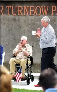  ?? NWA Democrat-Gazette/FLIP PUTTHOFF ?? Walter Turnbow (left) and Springdale Mayor Doug Sprouse (right) applaud remarks Tuesday at the dedication of Walter Turnbow Park along Mill Creek in downtown Springdale. The park is named for Turnbow, who has served Springdale for many years in several...