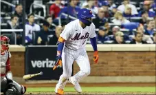  ?? JESSIE ALCHEH — THE ASSOCIATED PRESS ?? New York Mets’ Dominic Smith (2) drops his bat after hitting an RBIsingle to drive in Jeff McNeil and Pete Alonso against the Philadelph­ia Phillies during the fifth inning of a baseball game, Sunday, May 1, 2022, in New York.