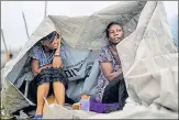  ?? REUTERS ?? Two women shelter from the rain at a makeshift camp in Les Cayes, Haiti on Tuesday.