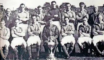  ?? ?? Ike Clarke, third from right in the front row, next to Pompey president Field Marshal Montgomery and the First Division trophy