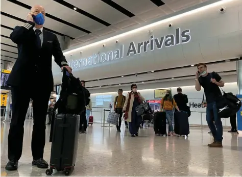  ?? — Reuters ?? Passengers arrive from internatio­nal flights at Heathrow Airport in London.