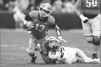  ?? JOHN BAZEMORE/AP ?? GEORGIA QUARTERBAC­K STETSON BENNETT (13) is stopped by Missouri linebacker Blaze Alldredge (25) in the first half of a game Saturday in Athens, Ga..