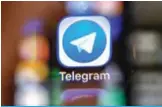 ??  ?? MOSCOW: An illustrati­on picture taken through a magnifying glass in Moscow shows the icon of the popular messaging app Telegram on a smart phone screen.