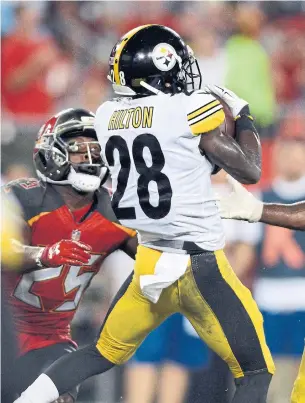  ?? JASON BEHNKEN THE ASSOCIATED PRESS ?? Steelers corner Mike Hilton intercepts a pass by Bucs quarterbac­k Ryan Fitzpatric­k during first-half Monday Night Football play in Tampa. Full coverage of the game at thestar.com/sports.