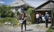  ?? ANDRIY ANDRIYENKO — THE ASSOCIATED PRESS ?? Residents remove debris from a destroyed house after Russian shelling in Kramatorsk, Ukraine, Wednesday.