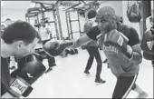  ?? EMMANUEL DUNAND / AGENCE FRANCE-PRESSE ?? Former internatio­nal middleweig­ht boxing champion and politican Bea Diallo, right, leads a training class in Brussels.