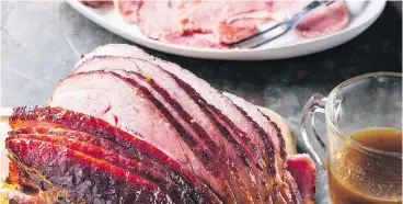  ?? — AMERICA’S TEST KITCHEN/THE ASSOCIATED PRESS ?? Spiral sliced ham is glazed with maple syrup and orange marmalade.