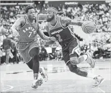  ?? NICK WASS THE ASSOCIATED PRESS ?? Wizards guard John Wall (2) drives to the basket against Toronto Raptors guard Kyle Lowry on Saturday in Washington.