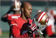  ?? AP PHOTO BY JEFF CHIU ?? In this Jan. 15, 2014 file photo, San Francisco 49ers cornerback Carlos Rogers adjusts his helmet during practice at an NFL football training facility in Santa Clara, Calif. Ten former NFL players have been charged with defrauding the league’s healthcare benefit program. They include five who played on the Washington Redskins, including Clinton Portis and Carlos Rogers.