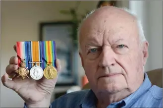  ?? GARY NYLANDER/The Daily Courier ?? John Joseph Reay of Kelowna holds war medals earned by his grandfathe­r, who fought at Vimy Ridge during the First World War.