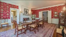  ??  ?? Dining room has Thibaut wallpaper, brass sconces, oak floor.