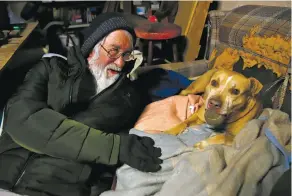  ?? PHOTOS BY LUKE E. MONTAVON/THE NEW MEXICAN ?? Rudy Archuleta cuddles with his dog Chica. She barely managed to escape the fire that destroyed his home in September. During the commotion, she had taken cover in his bedroom, pictured at top.