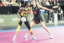  ?? FILE ?? Jamaica’s Malysha Kelly (left) looks to pass the ball as she is defended by New Zealand’s Maria Tutaia during a World Fast5 Netball Series semi-final match in Auckland, New Zealand, in 2012.