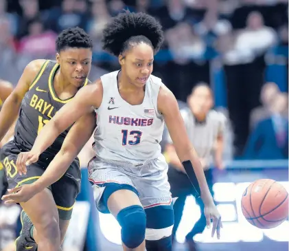  ?? BRAD HORRIGAN/HARTFORD COURANT ?? UConn’s Christyn Williams and Baylor’s Moon Ursin chase down a loose ball in the teams’last meeting Jan. 9, 2020, at XL Center in Hartford.