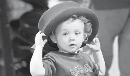  ?? KENNETH K. LAM/BALTIMORE SUN ?? Jedidiah Howard, 2, of White Marsh tries on a top hat that’s a few sizes too large for him Sunday at the 43rd Maryland Irish Festival at the Maryland State Fairground­s in Timonium.