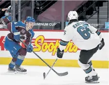  ?? Andy Cross, The Denver Post ?? Avalanche defenseman Bowen Byram, left, skates the puck against the defense of San Jose Sharks’ Erik Karlsson at Ball Arena on Thursday night.