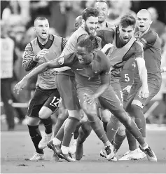  ??  ?? Portugal’s Eder (front, centre) celebrates after scoring against France during the Euro 2016 final. — AFP photo