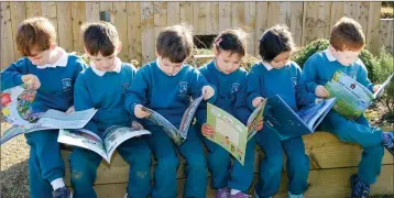  ??  ?? Infants Hugh Pearse, Tom Lawlor, Patrick Hickey, Alannah Mann, Aine Ryan and Mark Hogan getting stuck into the books donated by Delgany Tidy Towns at World Book Day in St Laurence’s NS, Kindlestow­n.