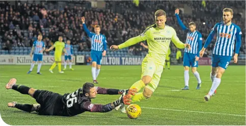  ??  ?? Hibs forward Florian Kamberi tries to take the ball round Kilmarnock goalkeeper Daniel Bachmann at Rugby Park