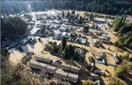  ?? JOSH EDELSON — THE ASSOCIATED PRESS ?? Flooding from the Russian River inundates Guernevill­e in 2019. Critics of a proposed riverfront resort in the area say it could further congest evacuation routes during natural disasters.