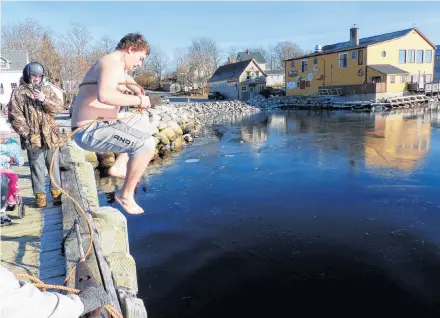  ?? Sue Deschene ?? J.T. Urquhart leaps into Shelburne Harbour during his Dec. 31 polar plunge.