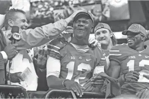  ?? ADAM CAIRNS/THE COLUMBUS DISPATCH ?? Urban Meyer had no idea what to expect when quarterbac­k Cardale Jones (12) was pressed into a starting role after J.T. Barrett’s injury, but the third-year sophomore made believers of Meyer and many others in the 2014 postseason.