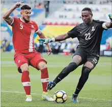  ?? ASSOCIATED PRESS FILE PHOTO ?? Canada’s Lucas Cavallini, left, battles French Guiana goalkeeper Donovan Leon during a CONCACAF Gold Cup match July 7, 2017.