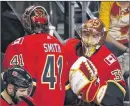  ?? CP PHOTO ?? Calgary Flames goaltender Mike Smith leaves the ice as goaltender David Rittich steps onto the ice during third period NHL action against the San Jose Sharks in Calgary on March 16.