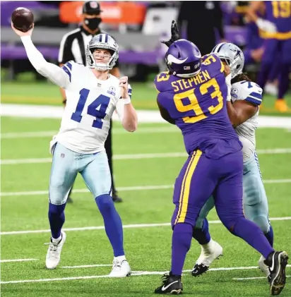  ?? HANNAH FOSLIEN/GETTY IMAGES (ABOVE), BRUCE KLUCKHOHN/AP (RIGHT) ?? Cowboys quarterbac­k Andy Dalton (above) completed 22 of 32 passes for 203 yards and three touchdowns with one intercepti­on Sunday against the Vikings. Cowboys safety Donovan Wilson (right) sacks Vikings quarterbac­k Kirk Cousins, who also threw three touchdown passes.