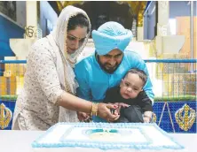 ?? RICHARD LAM ?? Aryan Deol gets a hand from mom Harpreet and father Gaganpreet as he celebrates his first birthday along with the family reaching its fundraisin­g goal of $3 million to treat his Type-1 Spinal Muscular Atrophy.