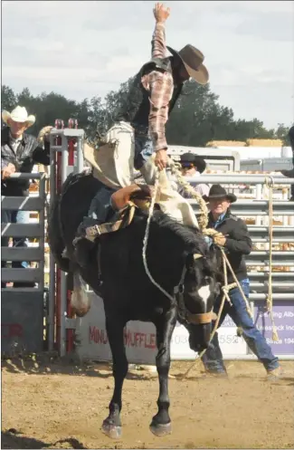  ??  ?? Hussar's Travis Finkbeiner grabbed some air in the saddle bronc event.