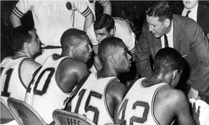  ?? Photograph: Anonymous/AP ?? Loyola coach George Ireland, right, talks to his team during the 1963 NCAA tournament.