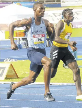  ??  ?? Antonio Watson (right) of Petersfiel­d High and Bryan Levell of Edwin Allen compete in semi-final two of the Class One 200m yesterday.