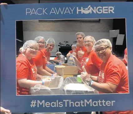  ?? RENEE MATCHETT PHOTOS ?? Living Hope Church in Merrillvil­le packed more than 40,000 meals for its Pack Away Hunger program during “Love Week” at the church last week.