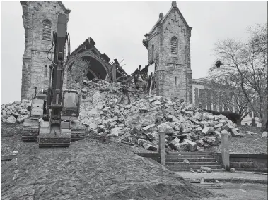  ?? DANA JENSEN/THE DAY ?? An excavator works on stabilizin­g the rubble pile to create an access route for the heavy demolition equipment at the collapsed First Congregati­onal Church in New London.