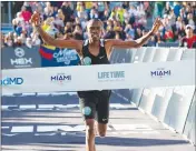  ?? Miami Herald/tns ?? Life Time Miami Marathon winner Saidi Juma Makula, 25, of Tanzania, crosses the finish line at 2:21:59 during the 18th annual Life Time Miami Marathon and Half Marathon in Miami on Sunday.