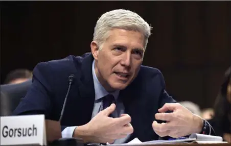  ?? SUSAN WALSH — THE ASSOCIATED PRESS FILE ?? Supreme Court Justice nominee Judge Neil Gorsuch explains mutton busting, an event held at rodeos similar to bull riding or bronc riding, in which children ride or race sheep, as he testifies on Capitol Hill in Washington during his confirmati­on...