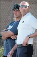  ?? CARLINE JEAN/SUN SENTINEL ?? Former Yankees Jorge Posada, left, and Derek Jeter, chief executive officer and part owner of the Marlins, check out the action during spring training in Jupiter.