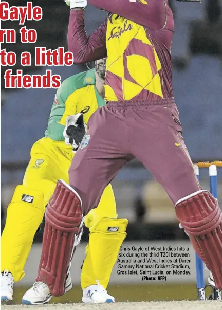  ?? (Photo: AFP) ?? Chris Gayle of West Indies hits a six during the third T20I between Australia and West Indies at Daren Sammy National Cricket Stadium, Gros Islet, Saint Lucia, on Monday.