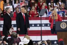  ?? Ben Gray/Associated Press ?? President Donald Trump shares the stage Saturday with U.S. Sens. Kelly Loeffler, R-Ga., and David Perdue, R-Ga., who are both facing runoff elections, during a rally in Valdosta, Ga.