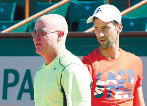  ?? AP FOTO ?? NEW DUO IN TOWN. After a series of losses in the past six months, Novak Djokovic fired his old coaching team and hired Andre Agassi in an attempt to end his slump.