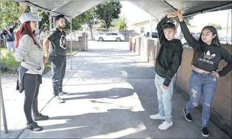  ?? Christina House Los Angeles Times ?? CYNTHIA GARCIA, left, leads a dance practice. She has seen empty quince halls and celebratio­ns postponed after venues have canceled.