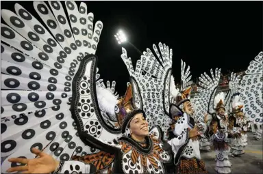  ?? (AP/Andre Penner) ?? Dancers from the Tom Maior samba school perform Saturday at a carnival parade in Sao Paulo, Brazil. More photos at arkansason­line.com/424carniva­l/.