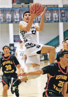  ??  ?? Jaguars senior wing T.J. Sanchez, left, and Demons junior post Fedonta ‘JB’ White, right, made the New Mexico High School Coaches Associatio­n’s Class 5A All-State squad Wednesday.