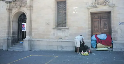  ?? Picture: Tracy Lee Stark ?? SEE YOU ON FRIDAY. A homeless man packs up his stuff outside an abandoned hospital ahead of the State of the Nation address by President Cyril Ramaphosa yesterday in Cape Town.