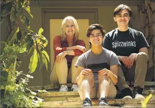  ?? Genaro Molina Los Angeles Times ?? DYLAN SCHIFRIN, center, with parents Lissa Kapstrom and Will Schifrin, was set to stage a capstone musical at Yale. The senior-year turmoil has been “heartbreak­ing,” his mother said.