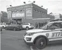  ?? JOHN MINCHILLO/AP ?? New York City police officers work the scene of a police-involved shooting at the 41st Precinct on Sunday.