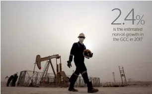 ?? — AP ?? A worker walks by a pump in the oil fields of Sakhir, Bahrain. Oil importers in the Mena region will see a pick-up in growth from 2.8 per cent in 2016 to 3.3 per cent in 2017 and four per cent in 2018.