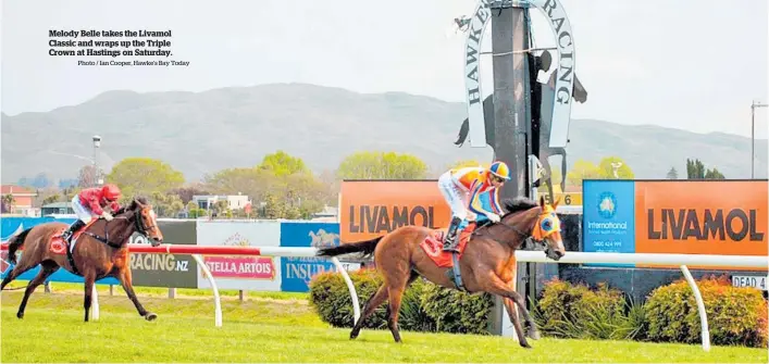  ?? Photo / Ian Cooper, Hawke’s Bay Today ?? Melody Belle takes the Livamol Classic and wraps up the Triple Crown at Hastings on Saturday.