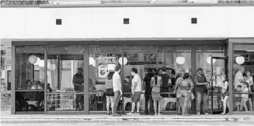  ?? JACOB LANGSTON/STAFF PHOTOGRAPH­ER ?? People line up outside the door of the Waffle House on Douglas Avenue in Altamonte Springs. Central Floridians are on the hunt for any place with food and air conditioni­ng as thousands of homes in the area are still without power.